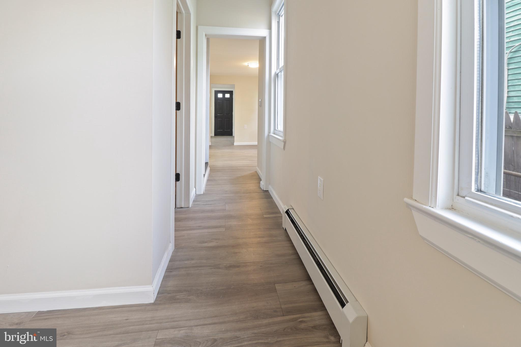 155 7th Street Salem, NJ 08079 - Photo 3 of 20 a view of a hallway with wooden floor