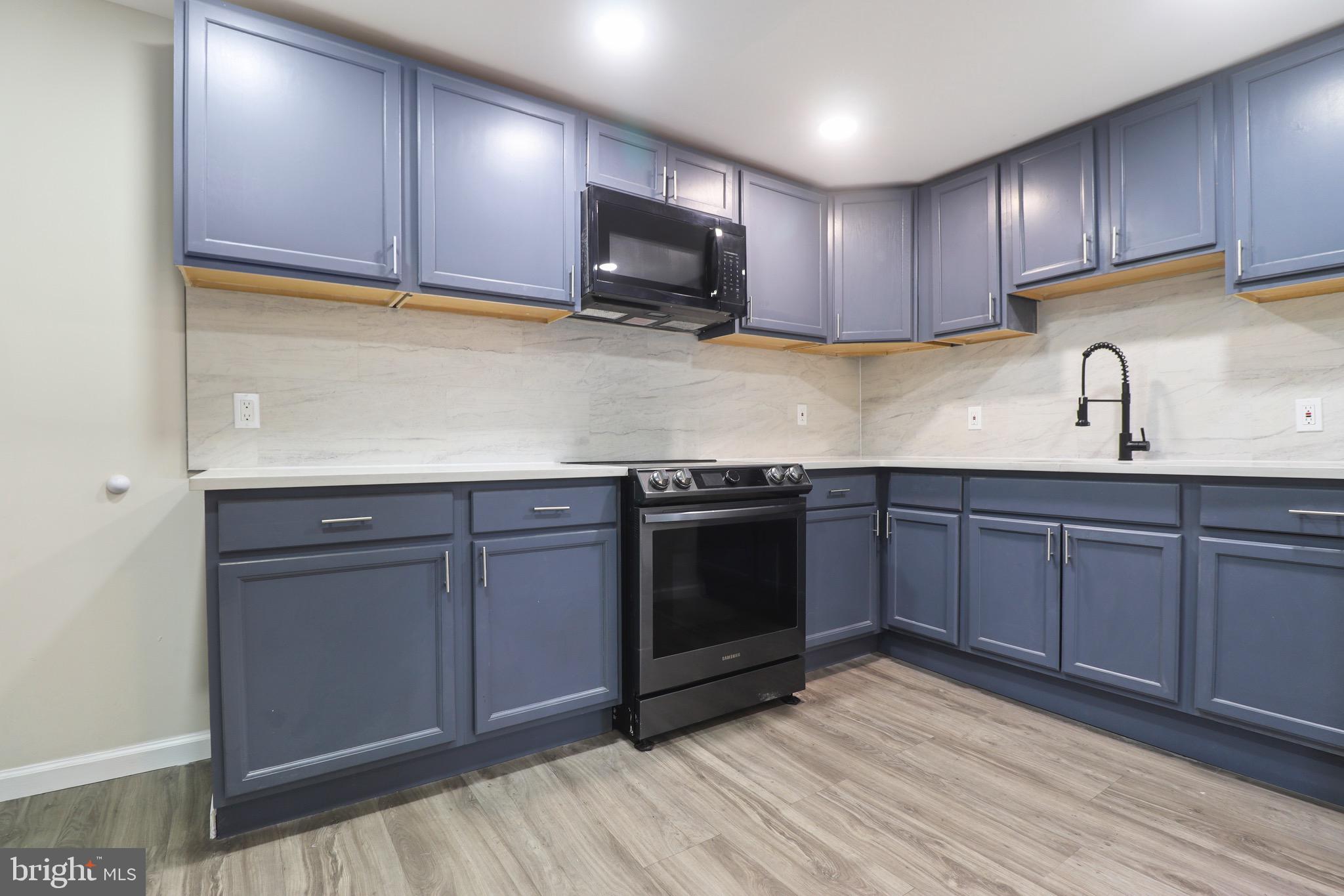 155 7th Street Salem, NJ 08079 - Photo 6 of 20 a kitchen with stainless steel appliances granite countertop wooden cabinets a stove top oven a sink and dishwasher