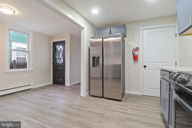 a kitchen with stainless steel appliances granite countertop a refrigerator and a stove top oven