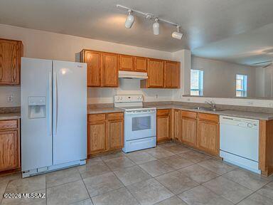 3248 West Treece Place Tucson, AZ 85742 - Photo 8 of 17 a kitchen with a stove sink and refrigerator