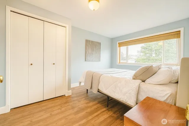 a bedroom with a bed and a window with outer view