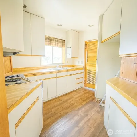 a kitchen with a stove a sink and a refrigerator