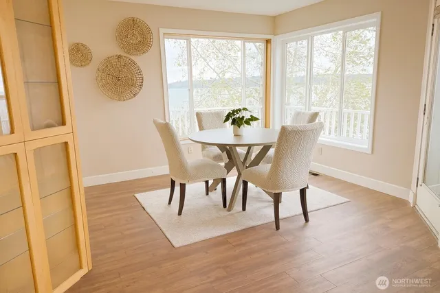 a view of a dining room with furniture and wooden floor