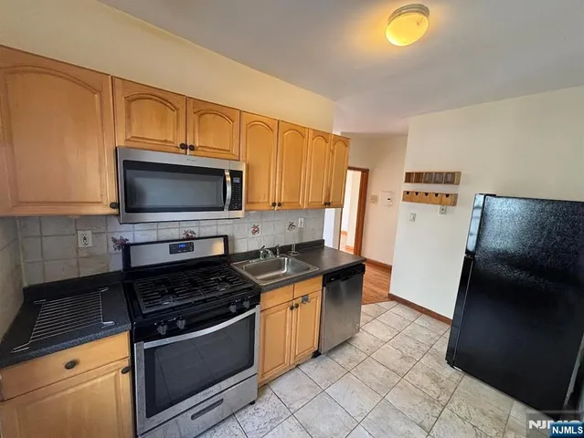 a kitchen with stainless steel appliances a stove a microwave and a refrigerator