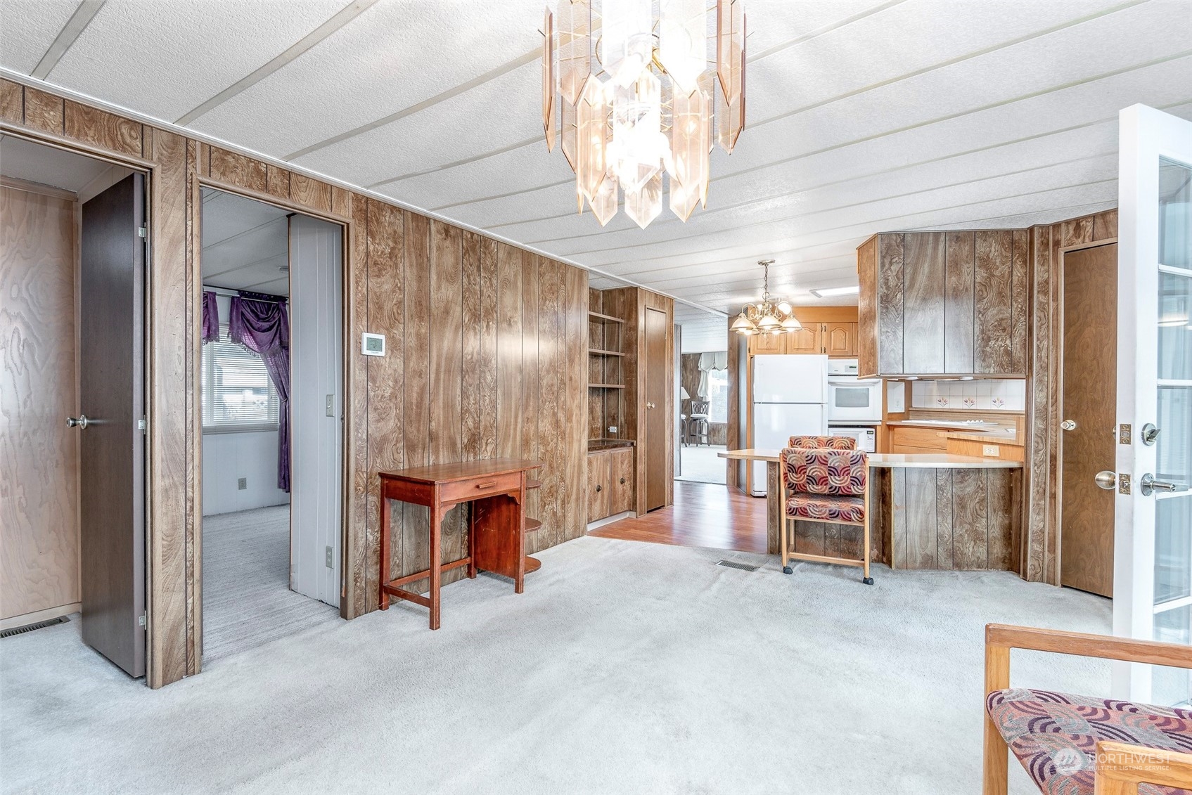 201 Union Avenue Southeast, Unit 99 Renton, WA 98059 - Photo 11 of 30 a room with stainless steel appliances kitchen island granite countertop furniture and a chandelier