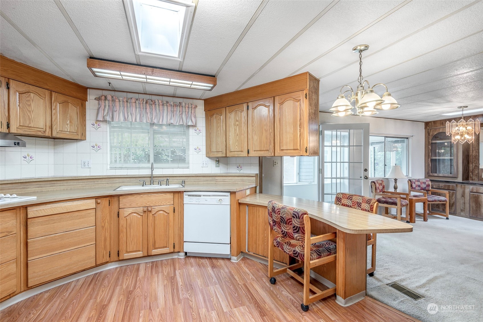 201 Union Avenue Southeast, Unit 99 Renton, WA 98059 - Photo 8 of 30 a kitchen with stainless steel appliances granite countertop wooden floors and white cabinets