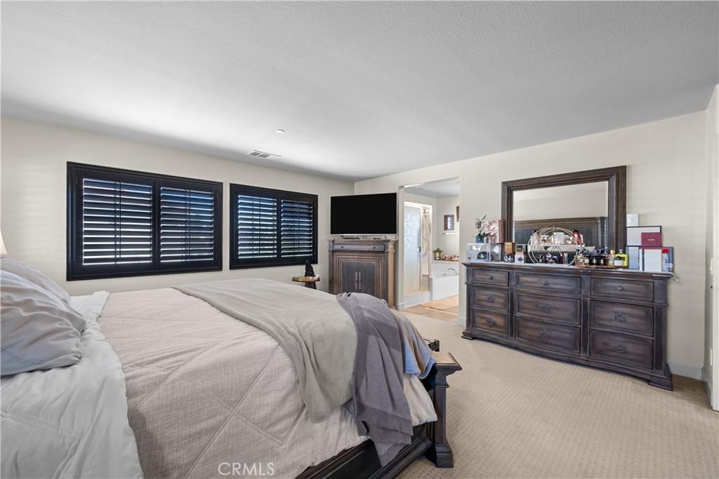 7925 Hemingway Court Fontana, CA 92336 - Photo 13 of 30 a bedroom with a large bed and a dresser