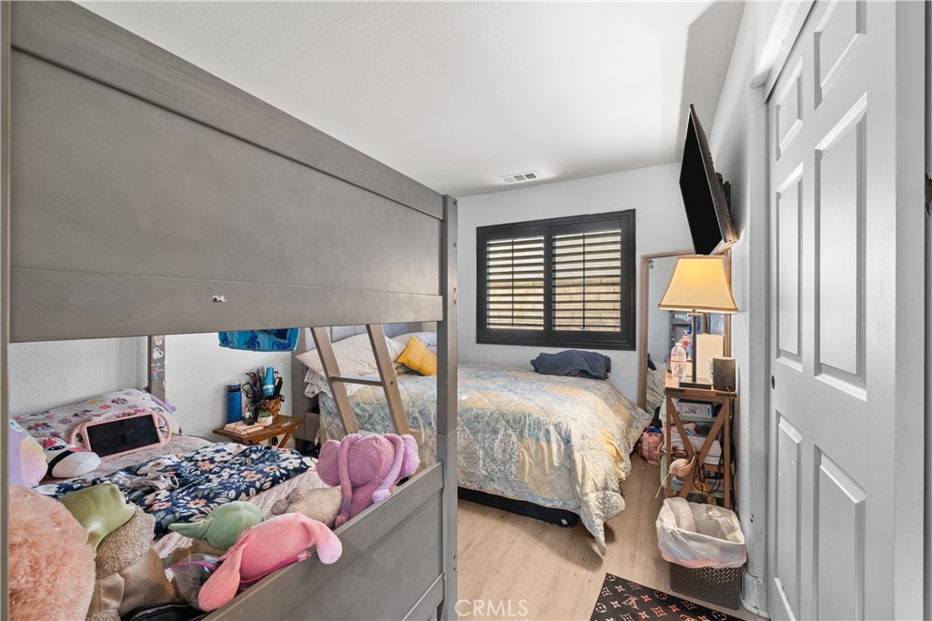 7925 Hemingway Court Fontana, CA 92336 - Photo 17 of 30 a bedroom with bed and a window