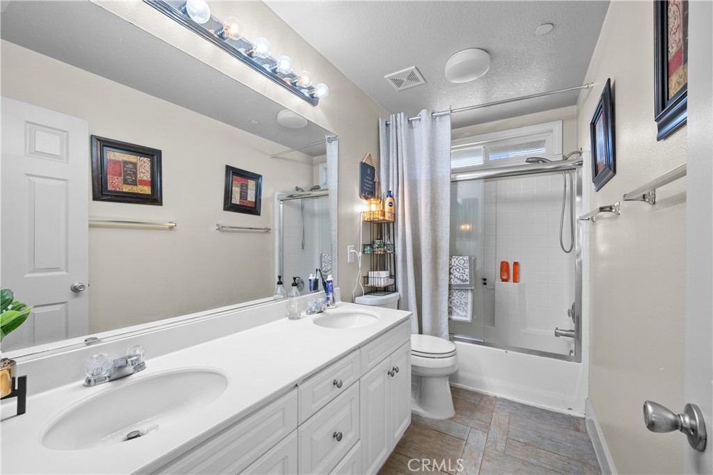 7925 Hemingway Court Fontana, CA 92336 - Photo 21 of 30 a bathroom with a double vanity sink mirror and toilet