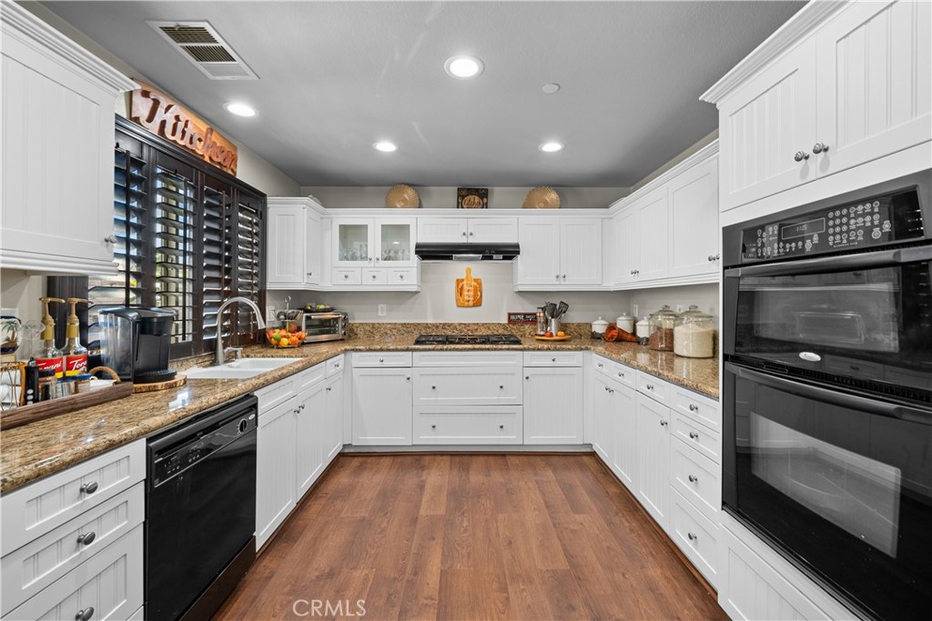7925 Hemingway Court Fontana, CA 92336 - Photo 6 of 30 a kitchen with stainless steel appliances granite countertop a stove sink and cabinets