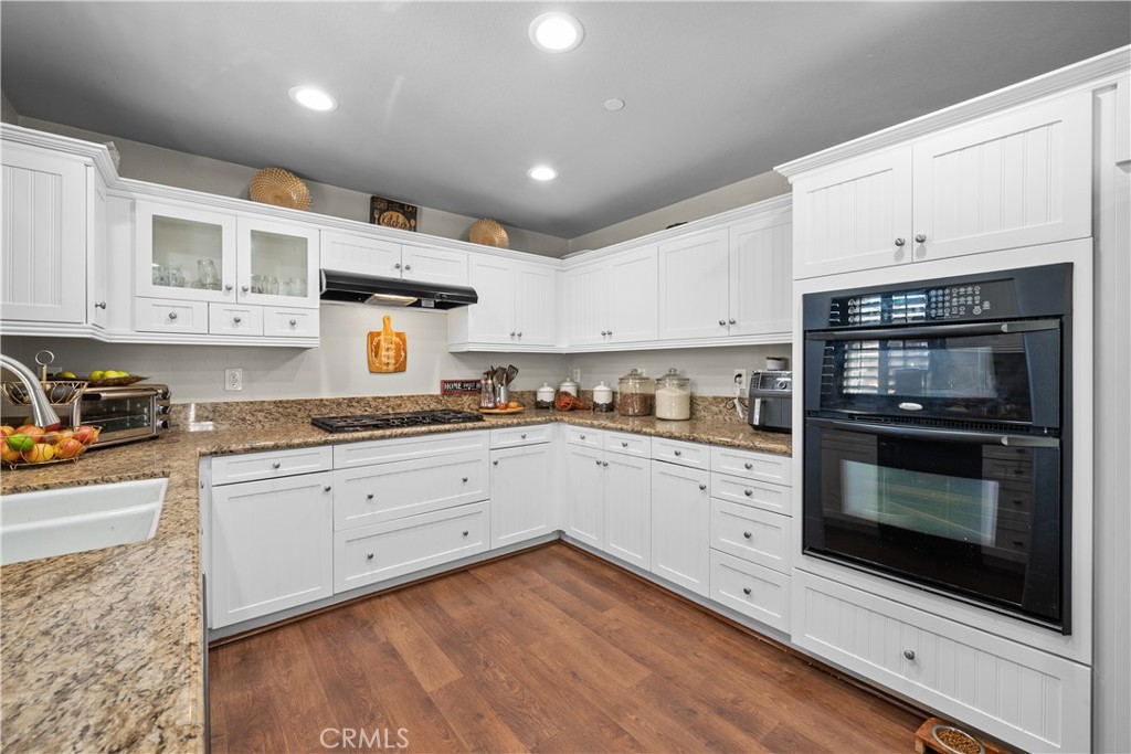 7925 Hemingway Court Fontana, CA 92336 - Photo 7 of 30 a kitchen with stainless steel appliances granite countertop a stove microwave and cabinets