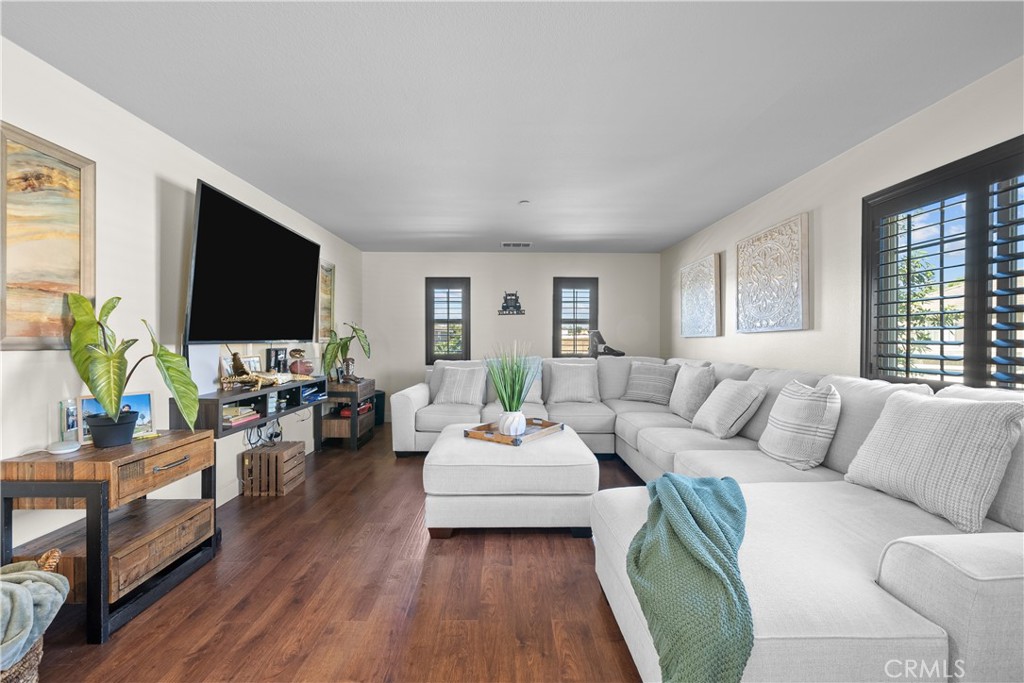 7925 Hemingway Court Fontana, CA 92336 - Photo 10 of 30 a living room with furniture flat screen tv and wooden floor