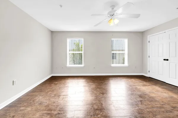 wooden floor in an empty room with a window