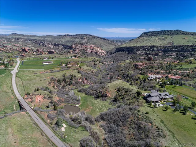 a view of a lush green hillside and houses