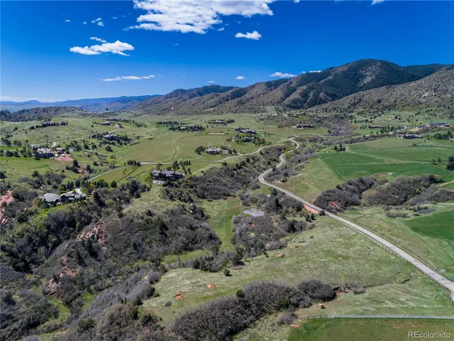 a view of a mountain with a field