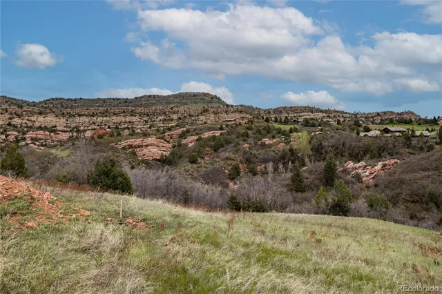 a view of a lush green hillside and houses