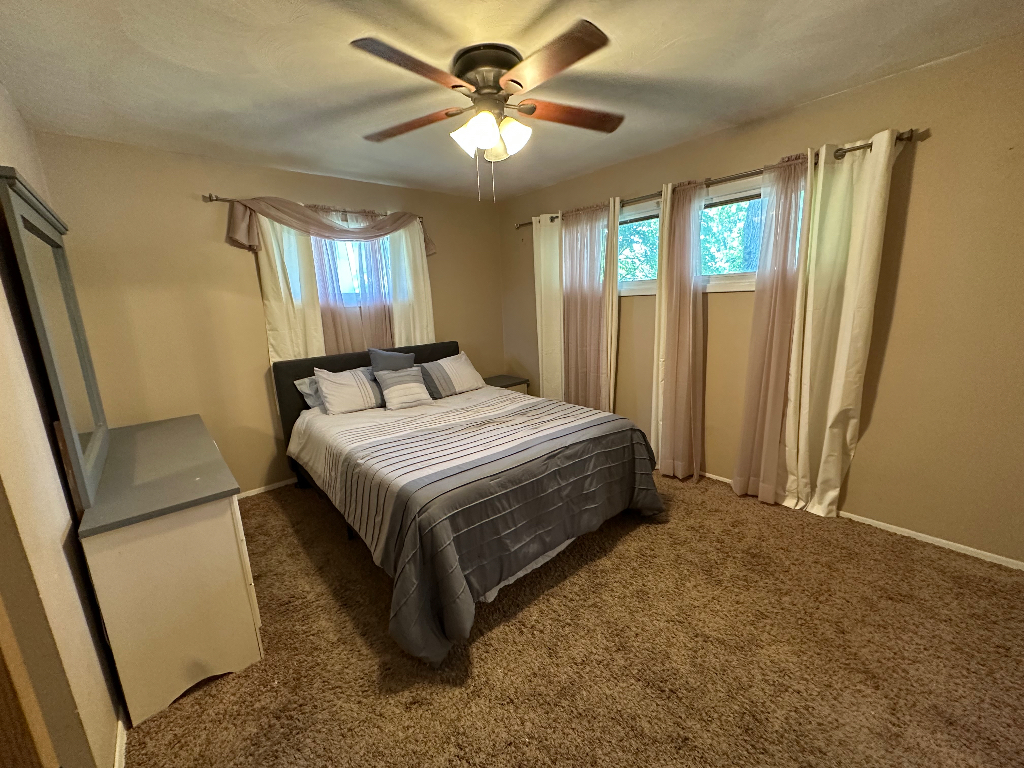 204 Rayjon Drive Oreana, IL 62554 - Photo 18 of 25 a bedroom with a large bed and a chandelier