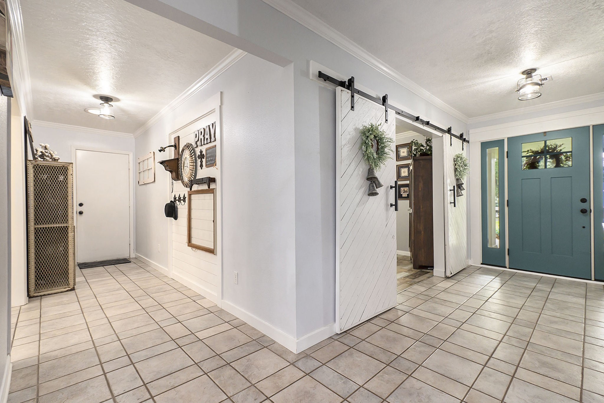 7363 County Line Road Willis, TX 77378 - Photo 4 of 34 Inviting entryway with chic barn doors and convenient garage access.