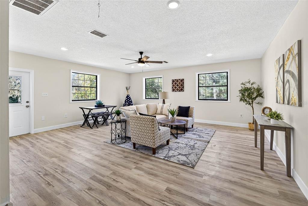 14252 Trinity Road Brooksville, FL 34614 - Photo 9 of 26 a living room with furniture and wooden floor
