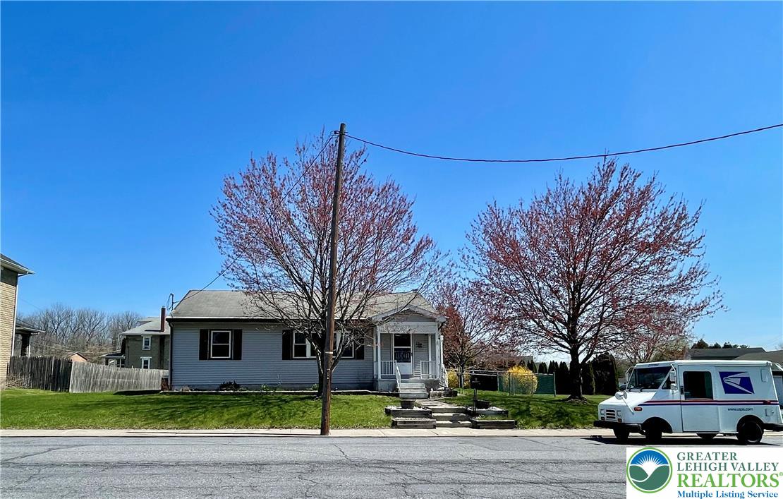 283 Broad Street Bath, PA 18014 - Photo 1 of 36 a front view of a house with a garden and trees