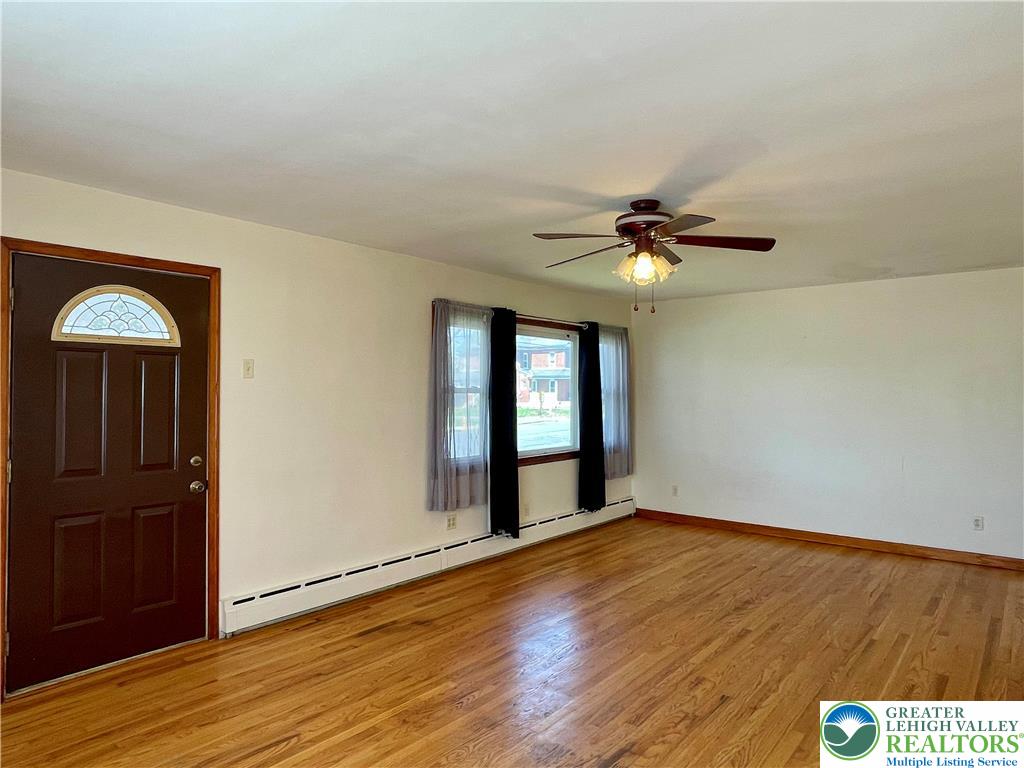 283 Broad Street Bath, PA 18014 - Photo 14 of 36 an empty room with wooden floor fan and windows
