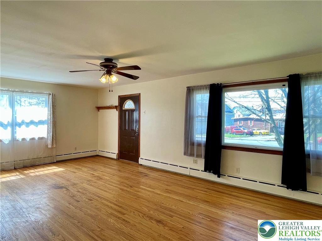 283 Broad Street Bath, PA 18014 - Photo 16 of 36 an empty room with wooden floor and windows