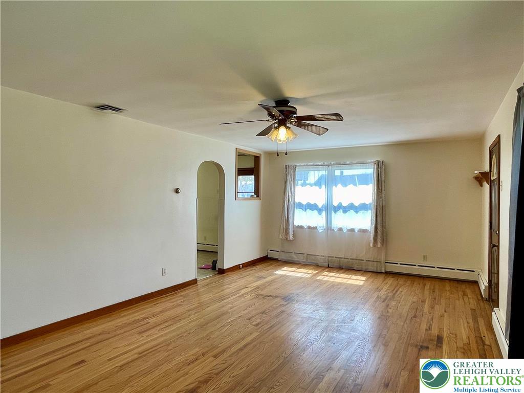 283 Broad Street Bath, PA 18014 - Photo 17 of 36 an empty room with wooden floor and windows