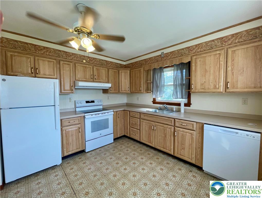 283 Broad Street Bath, PA 18014 - Photo 20 of 36 a kitchen with a sink cabinets stainless steel appliances and a window