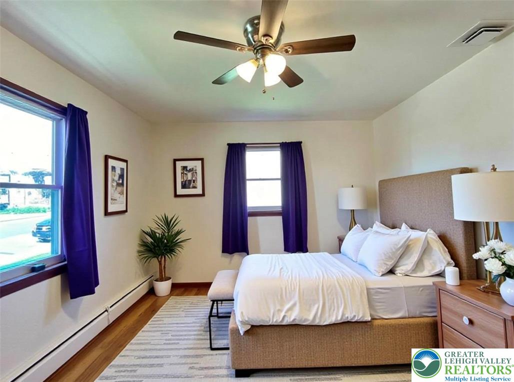 283 Broad Street Bath, PA 18014 - Photo 23 of 36 a bedroom with a large bed and a chandelier
