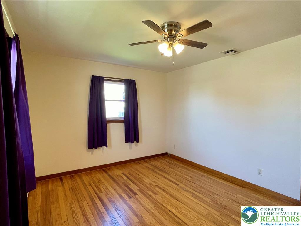 283 Broad Street Bath, PA 18014 - Photo 24 of 36 a view of an empty room with window and wooden floor