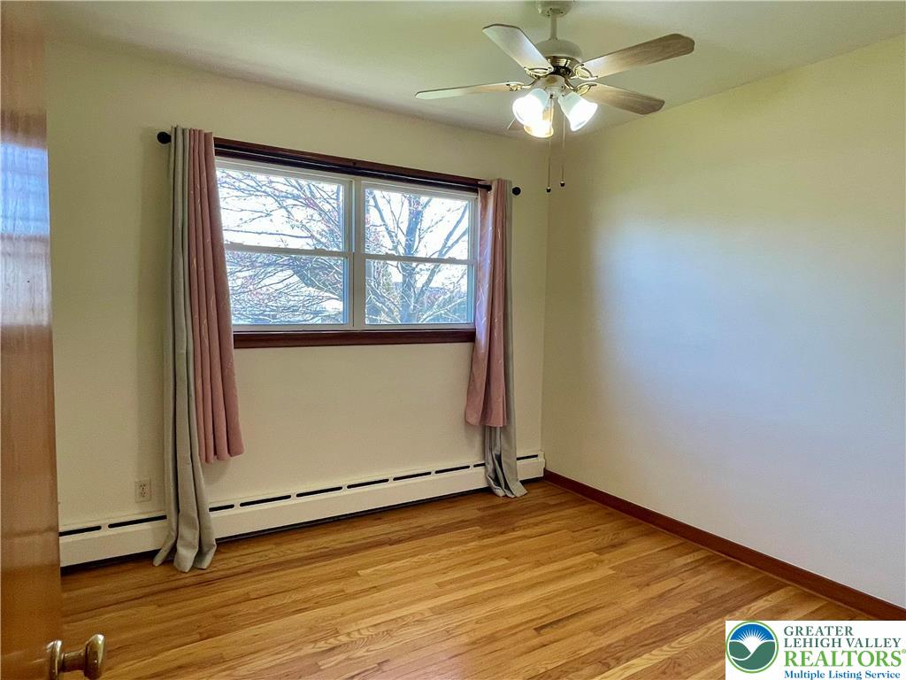 283 Broad Street Bath, PA 18014 - Photo 27 of 36 an empty room with wooden floor and windows