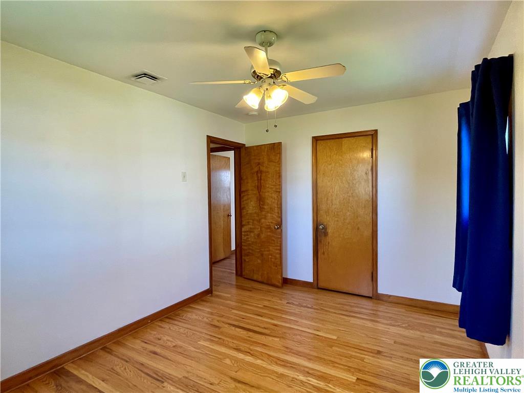 283 Broad Street Bath, PA 18014 - Photo 30 of 36 a view of an empty room with wooden floor and a ceiling fan
