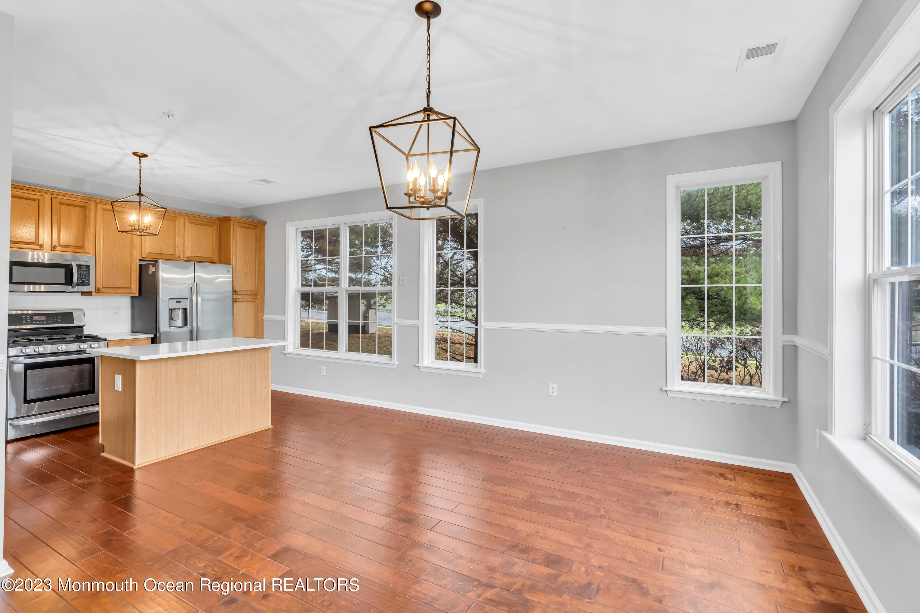 694 St Andrews Place Manalapan, NJ 07726 - Photo 16 of 21 a view of an empty room with a window and wooden floor