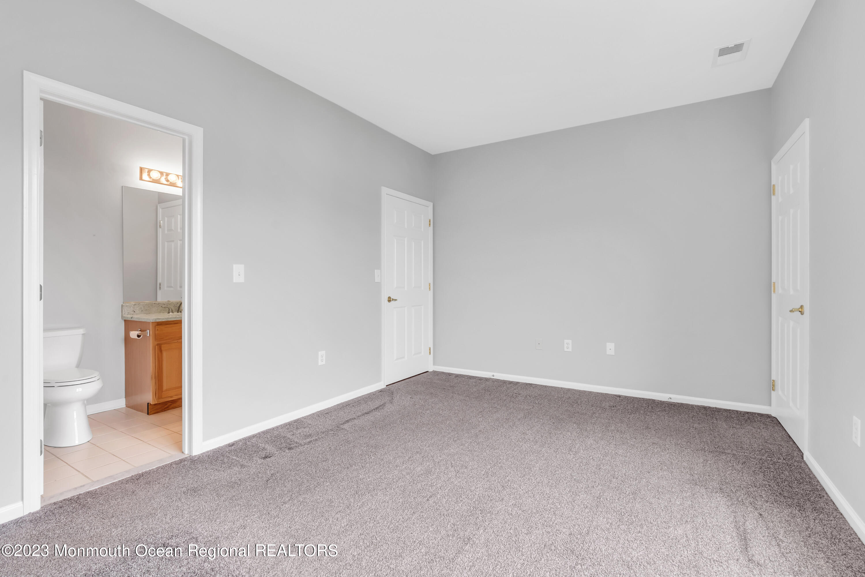694 St Andrews Place Manalapan, NJ 07726 - Photo 7 of 21 a view of an empty room and a gallery