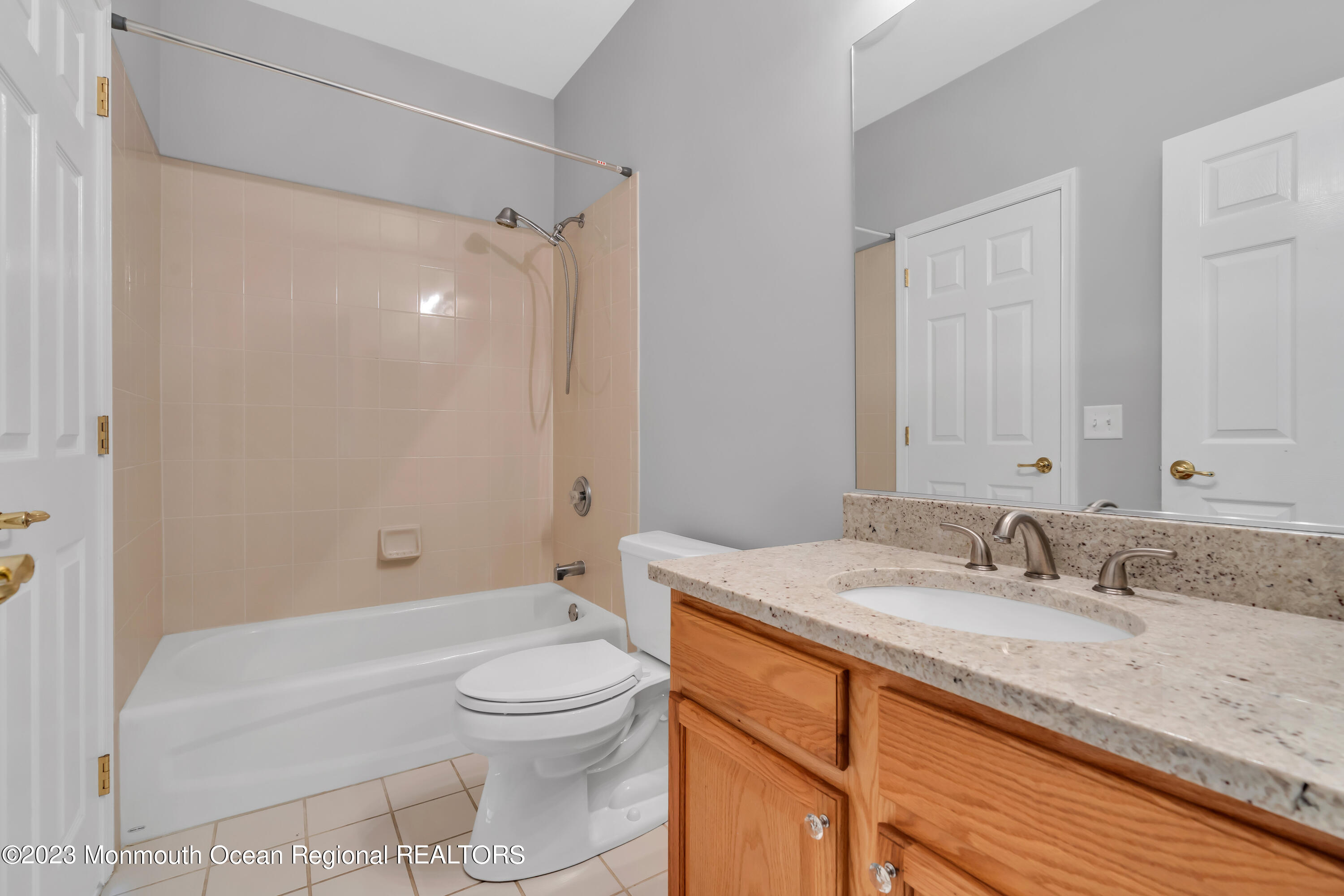694 St Andrews Place Manalapan, NJ 07726 - Photo 8 of 21 a bathroom with a granite countertop sink a toilet and shower