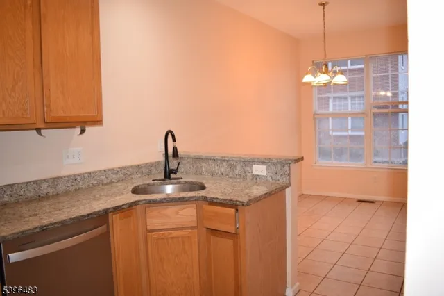 a kitchen with a sink refrigerator and cabinets