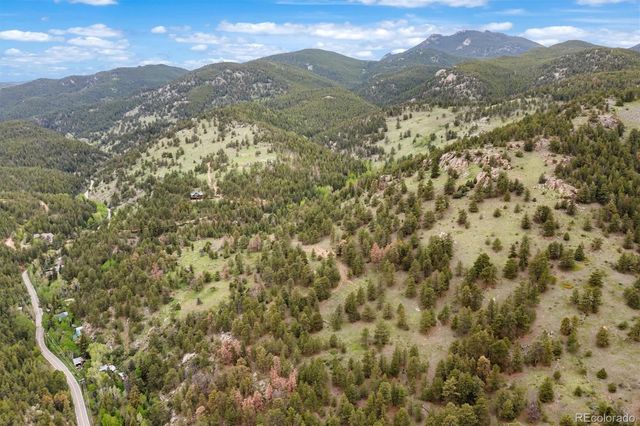 a view of a mountain range in a cloudy sky