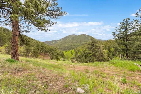 a view of mountain with yard