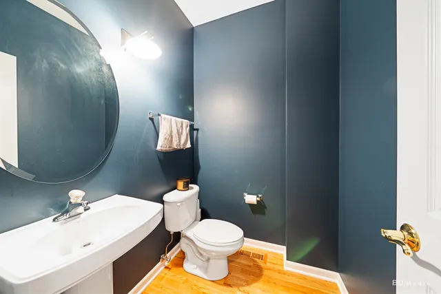 a bathroom with a sink mirror vanity and toilet