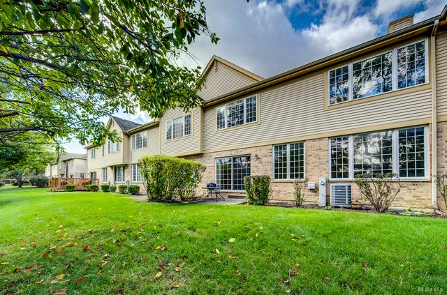 a view of a house with a yard and porch
