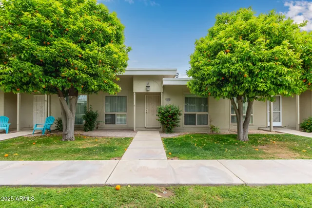 a front view of a house with a yard and a garage
