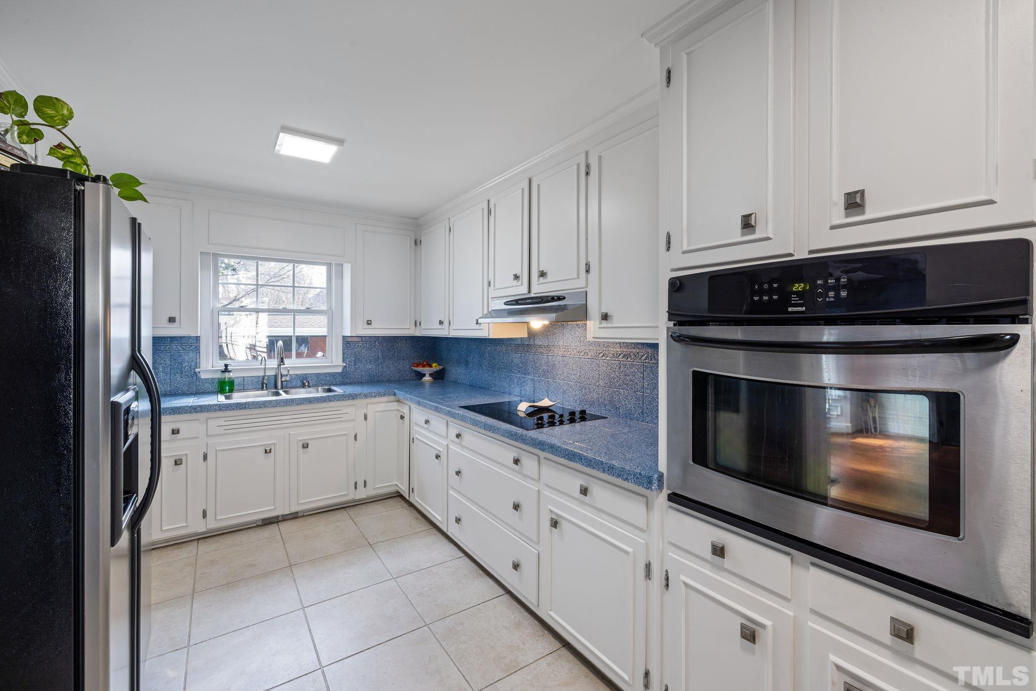 1110 Silas Ridge Court Raleigh, NC 27609 - Photo 13 of 43 a kitchen with granite countertop white cabinets and stainless steel appliances
