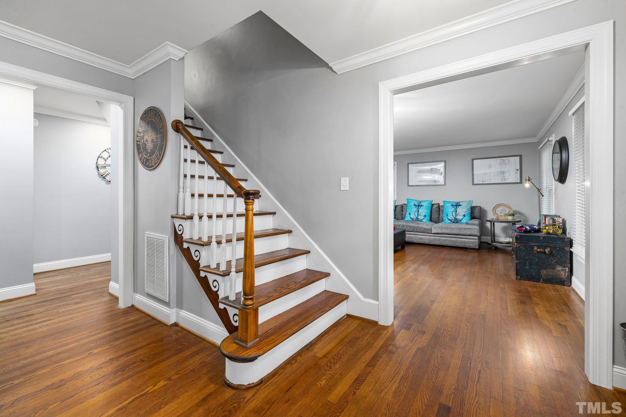 1110 Silas Ridge Court Raleigh, NC 27609 - Photo 9 of 43 a view of a hallway with wooden floor and stairs