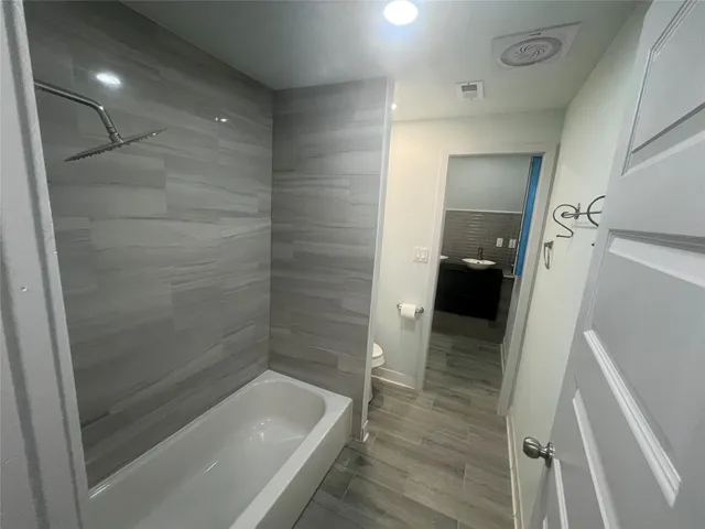 a bathroom with a bathtub and a shower