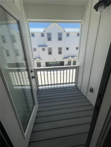 a view of staircase with wooden floor and white walls