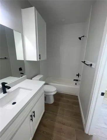 a bathroom with a sink a toilet and a bathtub