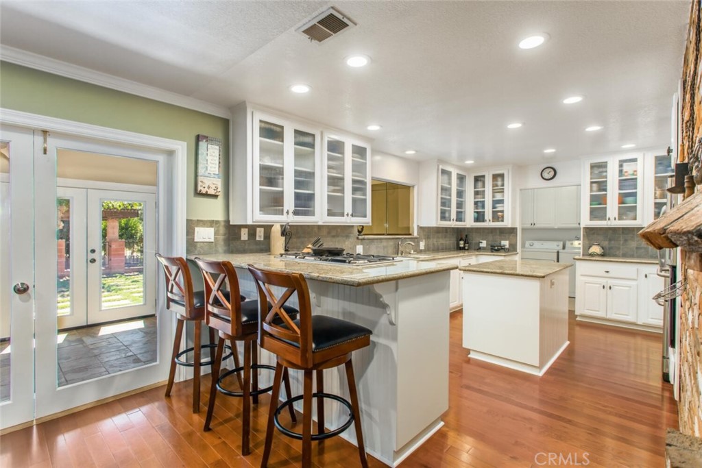 35893 Cornell Drive Yucaipa, CA 92399 - Photo 13 of 39 a kitchen with a table chairs sink and cabinets