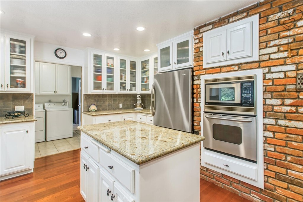 35893 Cornell Drive Yucaipa, CA 92399 - Photo 15 of 39 a kitchen with refrigerator cabinets and wooden floor