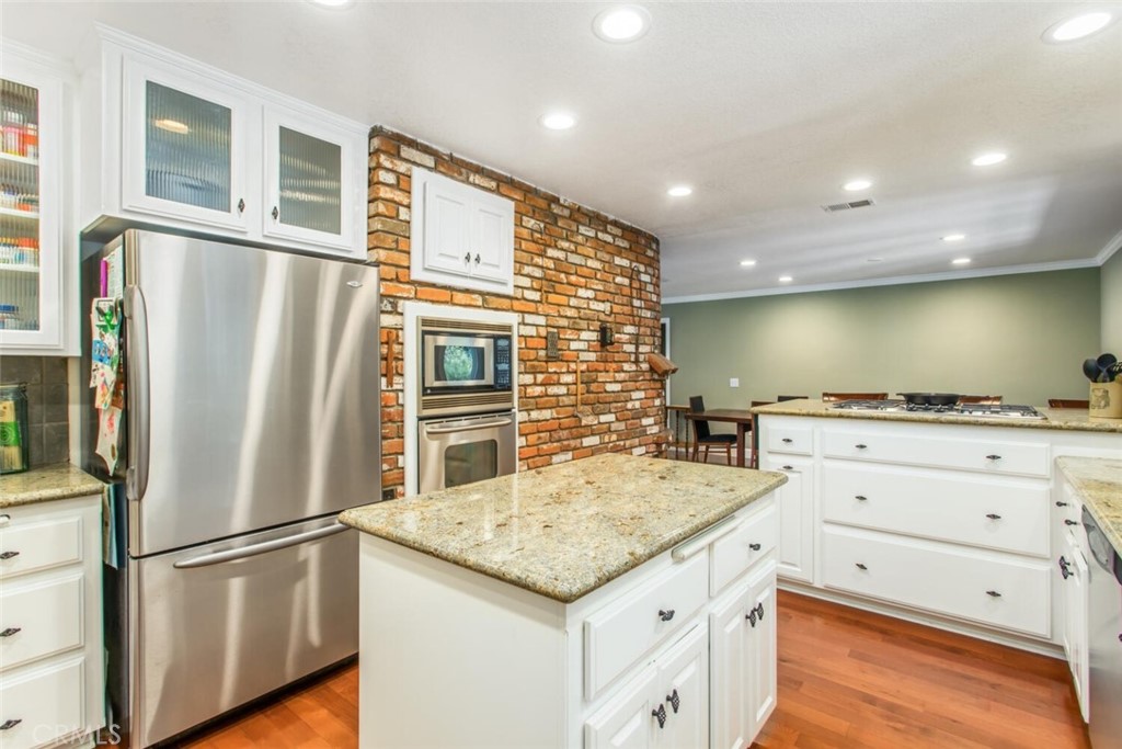 35893 Cornell Drive Yucaipa, CA 92399 - Photo 16 of 39 a kitchen with a refrigerator and countertop