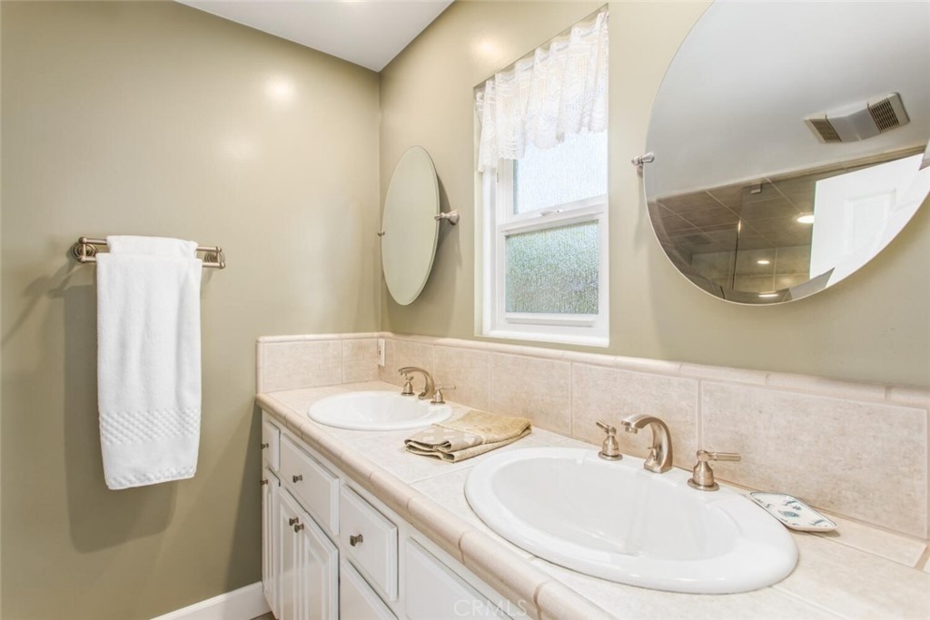 35893 Cornell Drive Yucaipa, CA 92399 - Photo 22 of 39 a bathroom with a sink and mirror